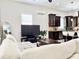 Inviting living room with a comfortable couch, television, and a view of the adjacent modern kitchen at 2137 W Saint Louis St, Tampa, FL 33607