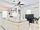 Bright and spacious living room featuring a sectional couch, modern décor, and a large television at 2137 W Saint Louis St, Tampa, FL 33607