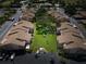 Aerial view of condos with mature trees and well maintained landscaping in the common areas at 2335 Beneva Ter # 2254, Sarasota, FL 34232