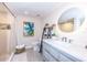 Well-lit bathroom with a modern vanity, circular mirror, and tiled shower with curtain at 2335 Beneva Ter # 2254, Sarasota, FL 34232