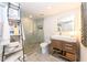 Modern bathroom featuring a glass-enclosed shower, floating vanity, and stylish storage ladder at 2335 Beneva Ter # 2254, Sarasota, FL 34232