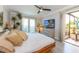 Bright bedroom with a wooden bed frame, neutral color palette, and sliding doors to an enclosed porch at 2335 Beneva Ter # 2254, Sarasota, FL 34232