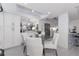 Open dining area with stylish white seating, modern lighting and a built-in bar area at 2335 Beneva Ter # 2254, Sarasota, FL 34232