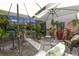 Outdoor patio area furnished with elegant wicker chairs and various plants around the table at 2335 Beneva Ter # 2254, Sarasota, FL 34232