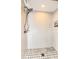 Clean, updated shower with a mosaic tile floor and white tiled walls and overhead shower faucet at 2335 Beneva Ter # 2254, Sarasota, FL 34232