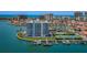 Stunning aerial of building's waterfront location with docks, pool, pickleball and city skyline backdrop at 240 Sand Key Estates Dr # 222, Clearwater, FL 33767