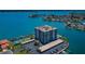 Overhead view of bayside condo community featuring a pool, tennis courts, boat docks and covered parking at 240 Sand Key Estates Dr # 222, Clearwater, FL 33767