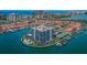 Aerial view of bayside condo community featuring a pool, tennis courts, and boat docks at 240 Sand Key Estates Dr # 222, Clearwater, FL 33767
