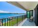 Balcony with water view, black railings, tile floor, and a chair at 240 Sand Key Estates Dr # 222, Clearwater, FL 33767