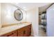 Bathroom with a wood vanity, granite counter, and walk in shower with shower curtain at 240 Sand Key Estates Dr # 222, Clearwater, FL 33767