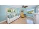 Well lit bedroom with a sofa, chair, dresser, ceiling fan, and a beautiful water view at 240 Sand Key Estates Dr # 222, Clearwater, FL 33767