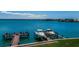 Water view of private boat docks with boat lift and boats on the canal and bay at 240 Sand Key Estates Dr # 222, Clearwater, FL 33767