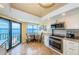 Modern kitchen with stainless steel appliances, granite counters, and eat-in breakfast nook at 240 Sand Key Estates Dr # 222, Clearwater, FL 33767
