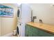 Laundry room with stackable washer and dryer, butcher block countertop and storage cabinet at 240 Sand Key Estates Dr # 222, Clearwater, FL 33767