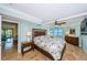 Serene main bedroom featuring water views, a ceiling fan, and a walk-in closet at 240 Sand Key Estates Dr # 222, Clearwater, FL 33767