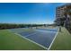Outdoor pickleball courts featuring green and blue surface, nets and fencing, perfect for recreational enjoyment at 240 Sand Key Estates Dr # 222, Clearwater, FL 33767