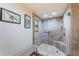 Tiled shower with bench seat and built-in shelf, glass enclosure, rainfall shower head, and safety bar at 240 Sand Key Estates Dr # 222, Clearwater, FL 33767