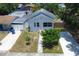 Aerial view of a home with a nice yard, driveway, landscaping, and a privacy fence at 2627 17Th N Ave, St Petersburg, FL 33713