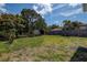 An outdoor area features a partial privacy fence and mature trees and shrubs at 2627 17Th N Ave, St Petersburg, FL 33713