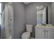 A well-lit bathroom features a toilet, vanity and shower with modern fixtures at 2627 17Th N Ave, St Petersburg, FL 33713