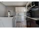 Bright kitchen with island, marble backsplash, stainless steel appliances, and modern white cabinetry at 2627 17Th N Ave, St Petersburg, FL 33713