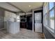 Bright kitchen features white cabinets, an island, and wood-look tile flooring at 2627 17Th N Ave, St Petersburg, FL 33713