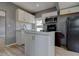 Modern kitchen featuring an island, bright white cabinets, and stainless steel appliances at 2627 17Th N Ave, St Petersburg, FL 33713