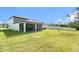 A large, manicured lawn extends from the home to the white fence at 30572 Thunderbird Dr, Wesley Chapel, FL 33545