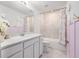 Delightful bathroom with a white vanity, shower-tub combo, and playful decor creating a cheerful space at 30572 Thunderbird Dr, Wesley Chapel, FL 33545