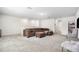 Large bonus room with carpeting, a sectional sofa, and versatile space for entertainment and relaxation at 30572 Thunderbird Dr, Wesley Chapel, FL 33545