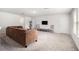 Spacious bonus room with neutral carpet, a sectional sofa, and plenty of space for various activities at 30572 Thunderbird Dr, Wesley Chapel, FL 33545