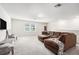 Comfortable bonus room featuring plush carpeting, a sectional sofa, and ample space for relaxation and entertainment at 30572 Thunderbird Dr, Wesley Chapel, FL 33545
