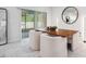 Cozy dining area with a wood table, plush chairs, modern light fixture, and sliding glass doors for easy access to the patio at 30572 Thunderbird Dr, Wesley Chapel, FL 33545
