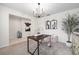 Modern dining room with sleek black chandelier and artistic decor at 30572 Thunderbird Dr, Wesley Chapel, FL 33545