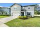 Two-story home with well-manicured lawn, landscaping, and an attached garage at 30572 Thunderbird Dr, Wesley Chapel, FL 33545