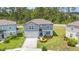 Aerial view of the two-story home with a well-maintained yard and landscaping at 30572 Thunderbird Dr, Wesley Chapel, FL 33545