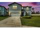 Beautiful two-story home with a manicured lawn and attached two-car garage at 30572 Thunderbird Dr, Wesley Chapel, FL 33545