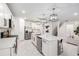 Modern kitchen boasts a large island, stainless appliances, and white cabinetry at 30572 Thunderbird Dr, Wesley Chapel, FL 33545