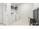 Clean laundry room with modern washer and dryer, plus storage shelving at 30572 Thunderbird Dr, Wesley Chapel, FL 33545
