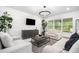 Bright living room with neutral decor, modern lighting, and comfortable seating at 30572 Thunderbird Dr, Wesley Chapel, FL 33545