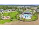 Community pool area with lounge chairs, a water slide, and a splash pad, surrounded by green space at 30572 Thunderbird Dr, Wesley Chapel, FL 33545