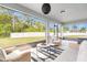 Relaxing screened porch furnished with comfortable seating and views of the fenced backyard at 30572 Thunderbird Dr, Wesley Chapel, FL 33545