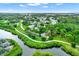 Aerial view of community featuring a river and lush greenery with tennis courts and a pool at 3229 40Th S Ln # C, St Petersburg, FL 33711