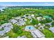 Aerial view of community featuring lush landscaping, swimming pool, and serene surroundings near the water at 3229 40Th S Ln # C, St Petersburg, FL 33711
