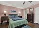 Charming bedroom features ceiling fan, hardwood floors, with coordinating nightstands, lamps, dressers and matching bed linens at 3229 40Th S Ln # C, St Petersburg, FL 33711
