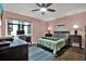 Comfortable bedroom features a ceiling fan, hard wood floors and large windows, and a desk for an office area at 3229 40Th S Ln # C, St Petersburg, FL 33711