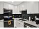 Modern kitchen features white cabinets, stainless steel appliances, black subway tile backsplash, and marble countertops at 3229 40Th S Ln # C, St Petersburg, FL 33711