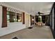 Enclosed lanai featuring an exterior door, multiple windows, ceiling fan, and table with 4 chairs at 3229 40Th S Ln # C, St Petersburg, FL 33711