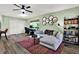 Living room features modern decor, ceiling fan, and a dedicated office space at 3229 40Th S Ln # C, St Petersburg, FL 33711