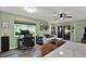 Bright living room featuring work area, large window, and sliding glass door to porch at 3229 40Th S Ln # C, St Petersburg, FL 33711